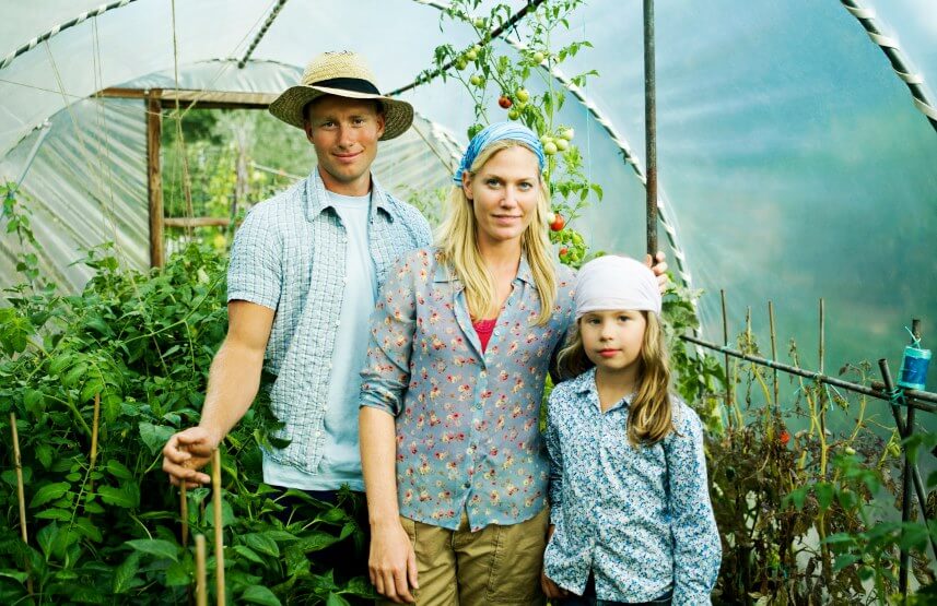 family gardening in greenhouse
