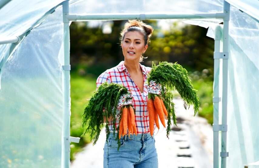 a woman gardening in urban greenhouse